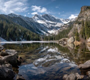 Landscape Rocky Mountains wilderness with rocky mountain range panorama glacial lake water rocky mountain spring thaw