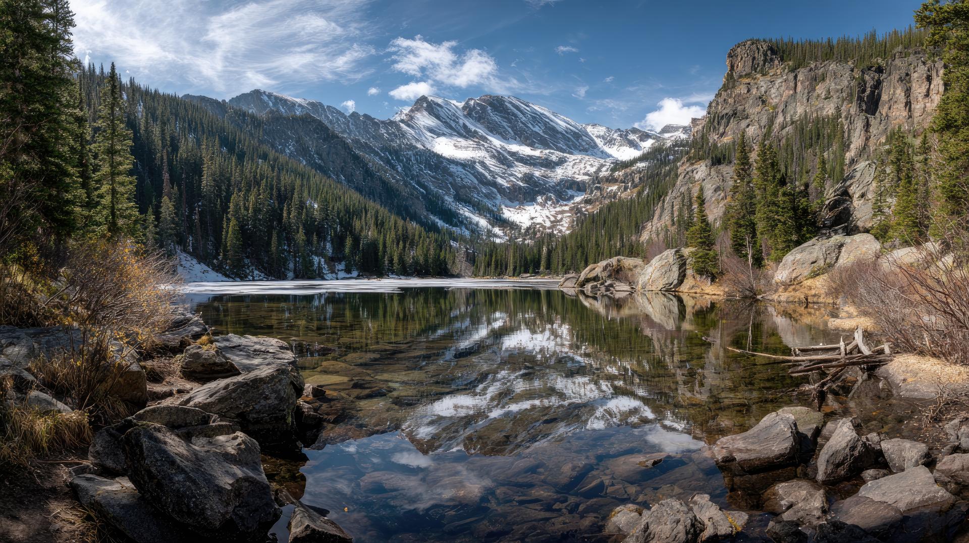 Landscape Rocky Mountains wilderness with rocky mountain range panorama glacial lake water rocky mountain spring thaw